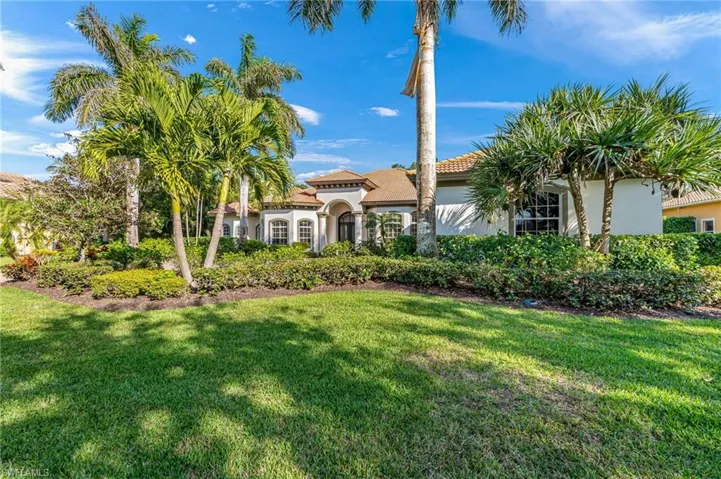 Mediterranean / spanish-style house featuring stucco siding and a front lawn