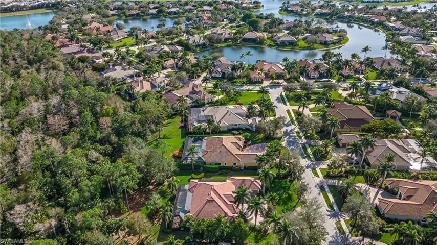Aerial view of property's location featuring nearby suburban area and a nearby body of water