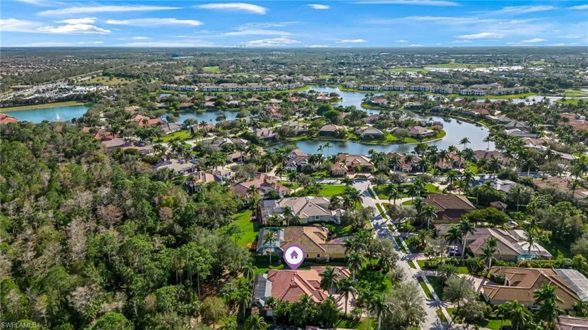 Aerial view of property's location with nearby suburban area and a nearby body of water