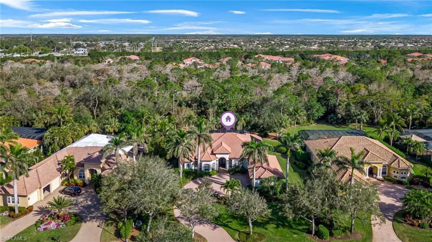 Aerial view of property and surrounding area with nearby suburban area