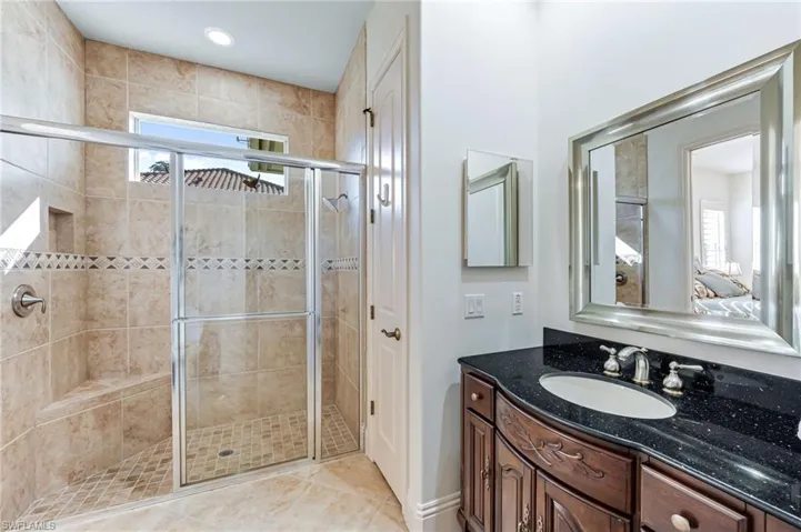 Bathroom with healthy amount of natural light, a stall shower, vanity, and ensuite bathroom