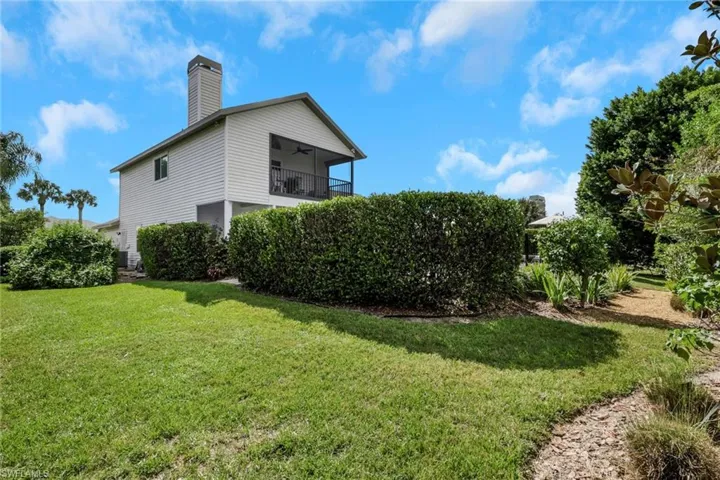 Traditional home with concrete driveway, a garage, a front lawn, and vinyl siding