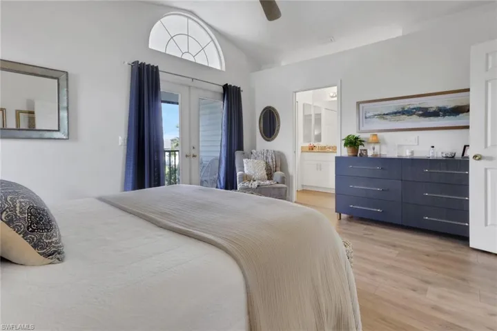 Bedroom with vaulted ceiling, ceramic tile flooring, new ceiling fan with French doors taking you out to the second story patio.