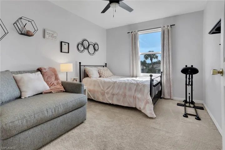 Primary bathroom with tiled shower and sliding window for extra light