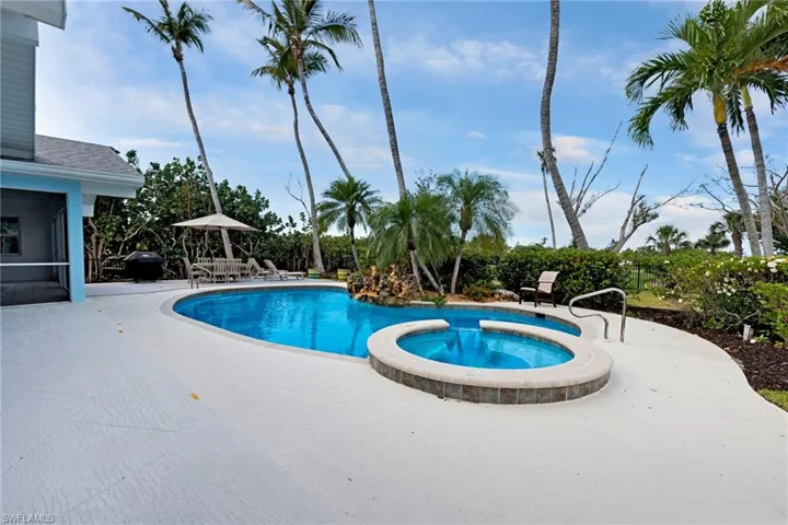 View of swimming pool featuring an in ground hot tub and a patio area