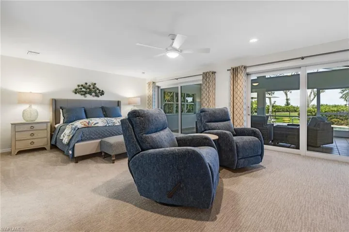 Carpeted bedroom featuring access to outside and ceiling fan
