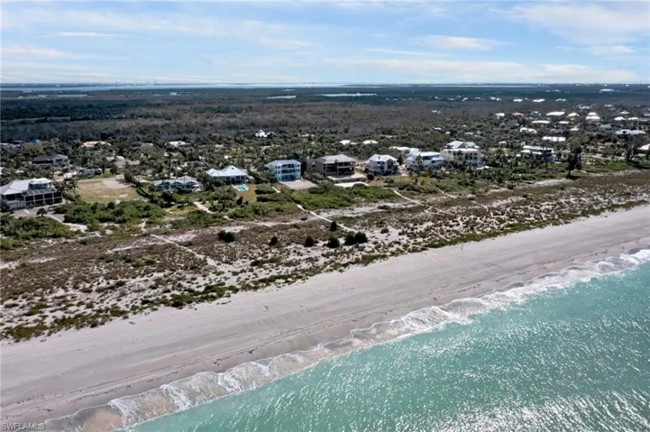 Drone / aerial view with a water view and a beach view