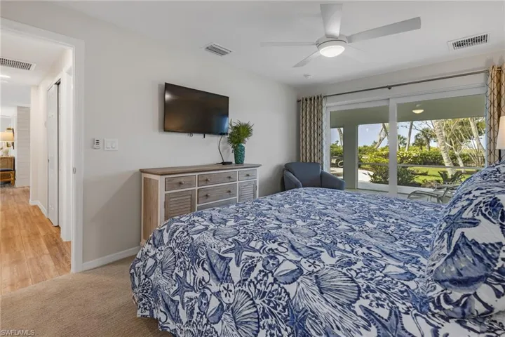 Carpeted bedroom featuring access to exterior and ceiling fan