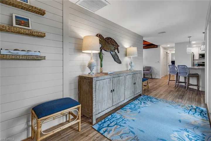 Corridor featuring hardwood / wood-style floors and wood walls