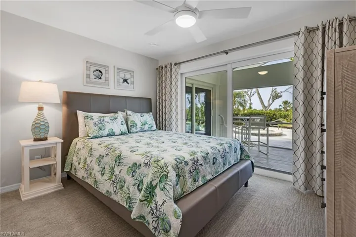 Bedroom featuring access to exterior, carpet, and ceiling fan