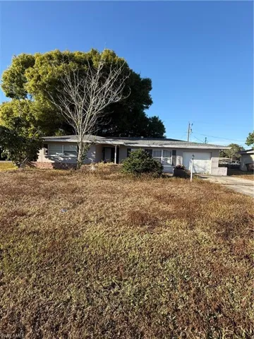 Ranch-style house with a garage and concrete driveway