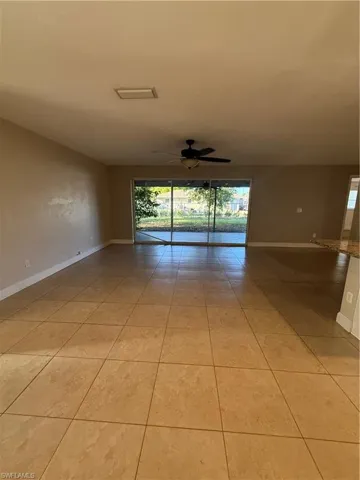 Spare room featuring ceiling fan and light tile patterned floors