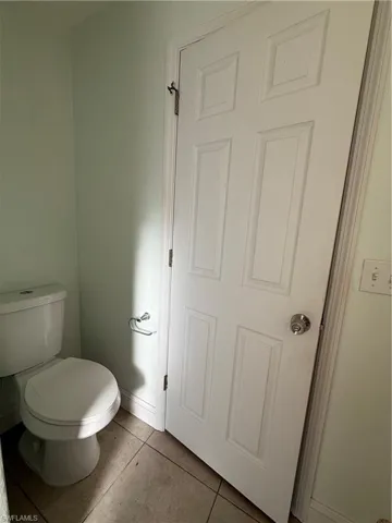 Bathroom with toilet and tile patterned flooring