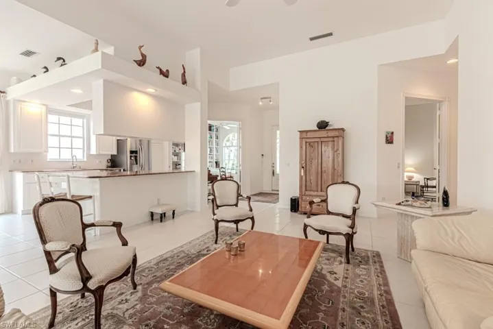 Living area featuring light tile patterned floors, ceiling fan, recessed lighting, and visible vents