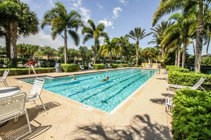 Pool with a patio area and fence