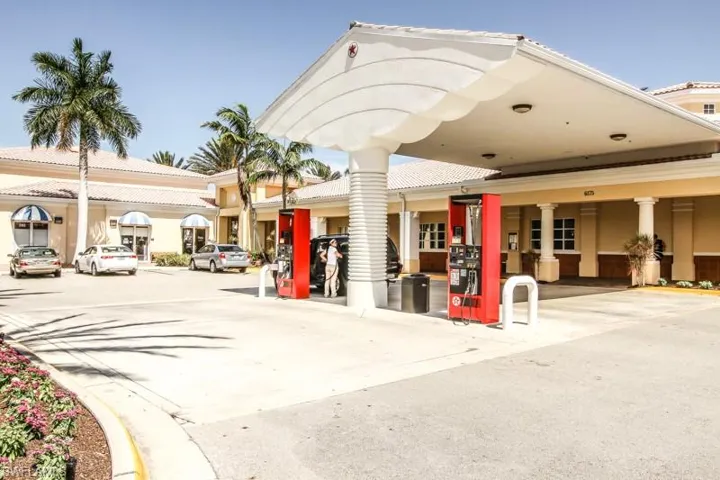 View of building exterior with uncovered parking