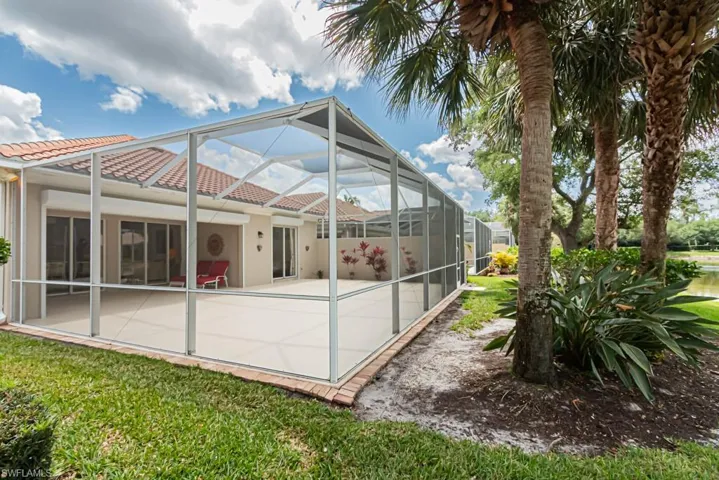 Back of property featuring a patio, stucco siding, a lanai, and a tile roof