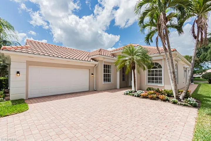 Mediterranean / spanish-style house featuring a tiled roof, a garage, stucco siding, and decorative driveway