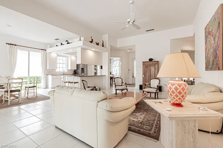 Living room featuring visible vents, ceiling fan, and light tile patterned floors