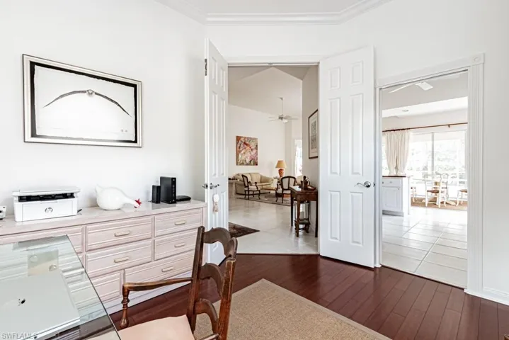 Corridor featuring crown molding and dark wood finished floors