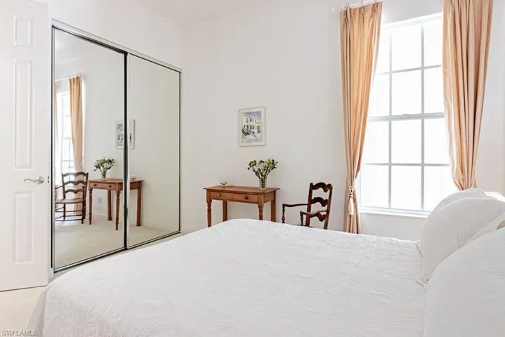 Carpeted bedroom featuring a closet