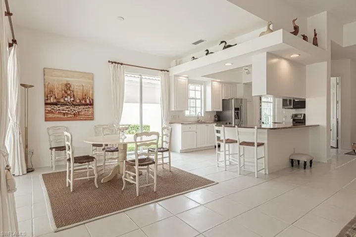 Unfurnished dining area featuring a sink, visible vents, and light tile patterned floors