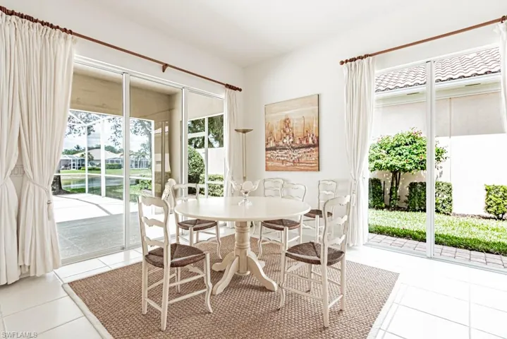 Dining space featuring light tile patterned floors