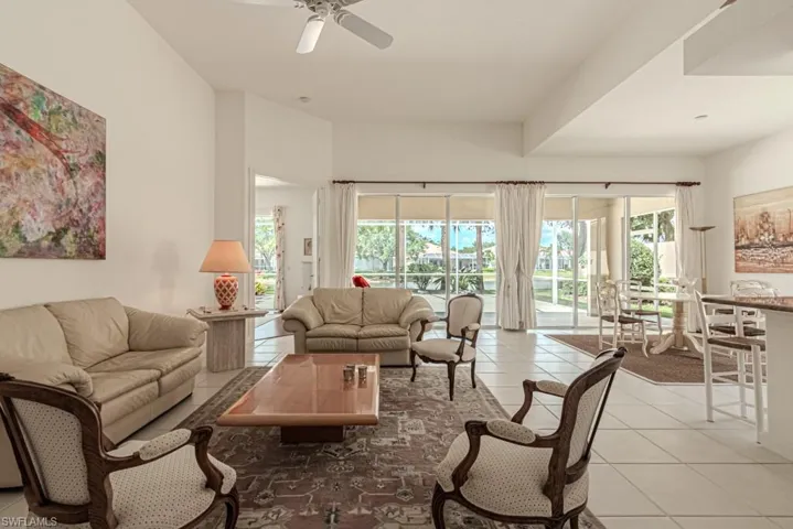 Living room featuring light tile patterned floors and ceiling fan