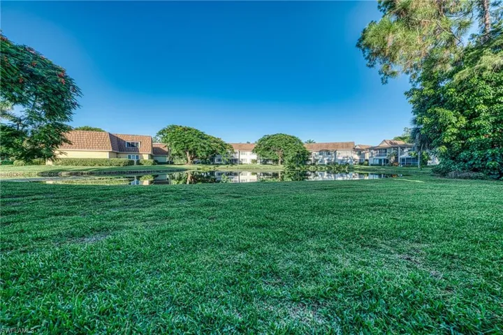 View of green lawn featuring a water view and a residential view