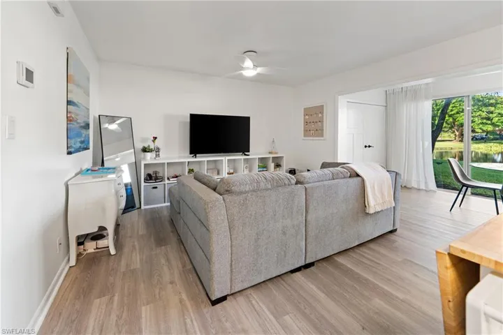 Living area with a ceiling fan and wood finished floors