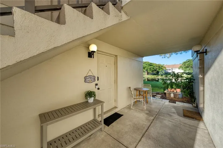 Doorway to property featuring stucco siding