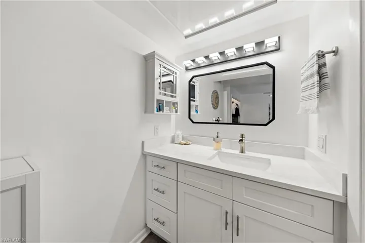 Bathroom featuring vanity and baseboards