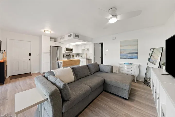 Living area with light wood-style floors and ceiling fan