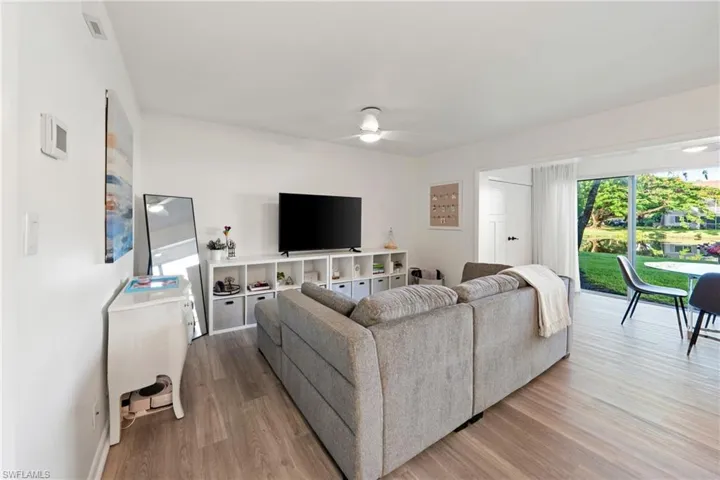 Living area with a ceiling fan and wood finished floors