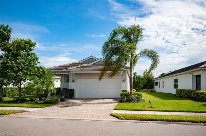 Ranch-style home with a garage and a front lawn