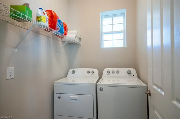 Clothes washing area featuring washer and clothes dryer