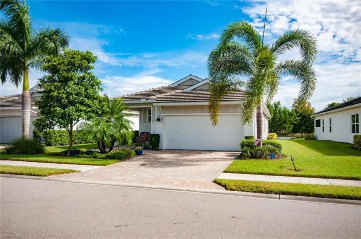View of front of home with a garage and a front yard