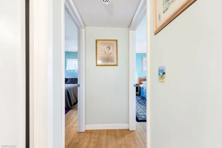 Hall featuring light wood-style flooring and baseboards