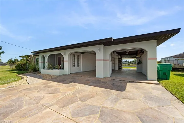 View of front of property with stucco siding and driveway