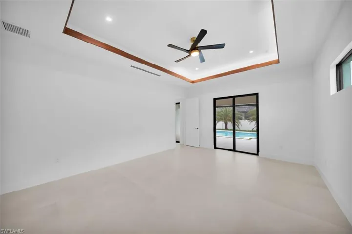 Spacious room featuring light-toned flooring and white walls