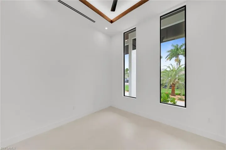 Interior space featuring two vertical windows with black trim