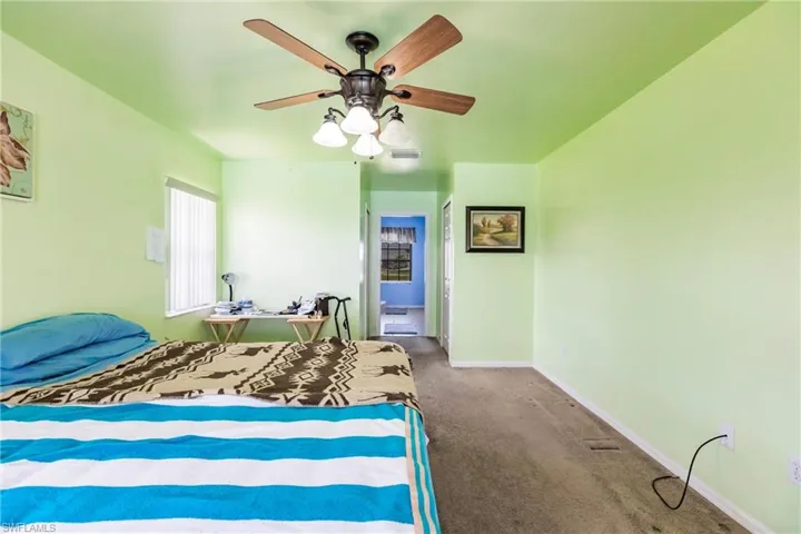 Carpeted bedroom with ceiling fan