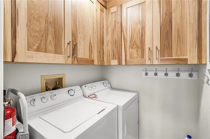 Laundry room with cabinet space and washing machine and clothes dryer