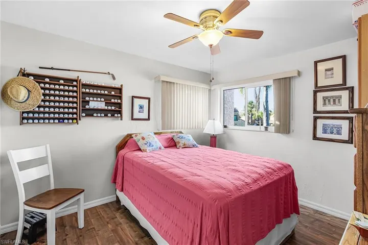 Bedroom featuring a ceiling fan and dark wood-type flooring