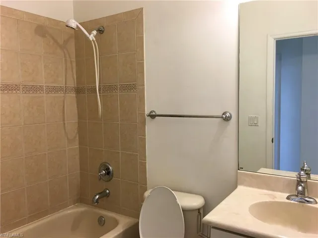 Bathroom featuring tub / shower combination and vanity
