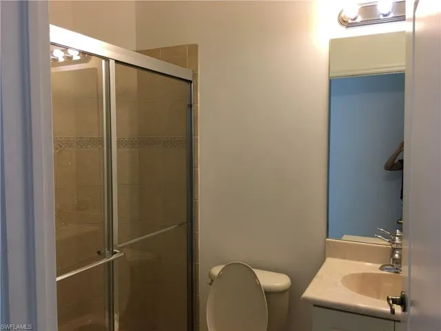 Bathroom featuring vanity and a stall shower