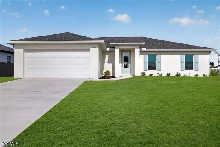 Contemporary single-story residence featuring a two-car garage, light stucco exterior, and a dark shingle roof