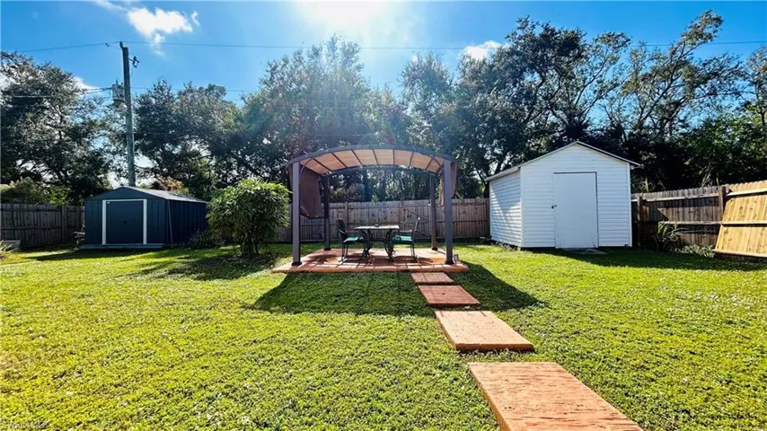 View of yard with a patio and a shed