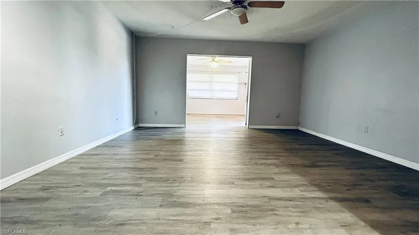 Empty room with hardwood / wood-style flooring