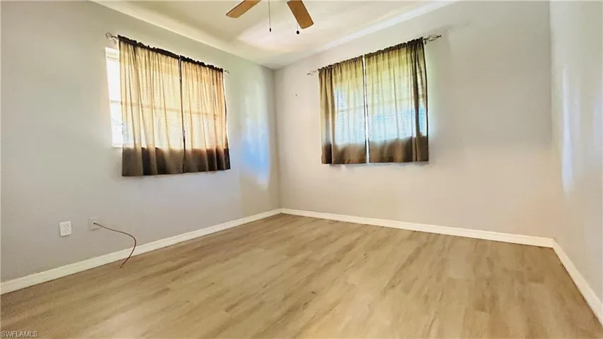 Spare room with hardwood / wood-style flooring and ceiling fan